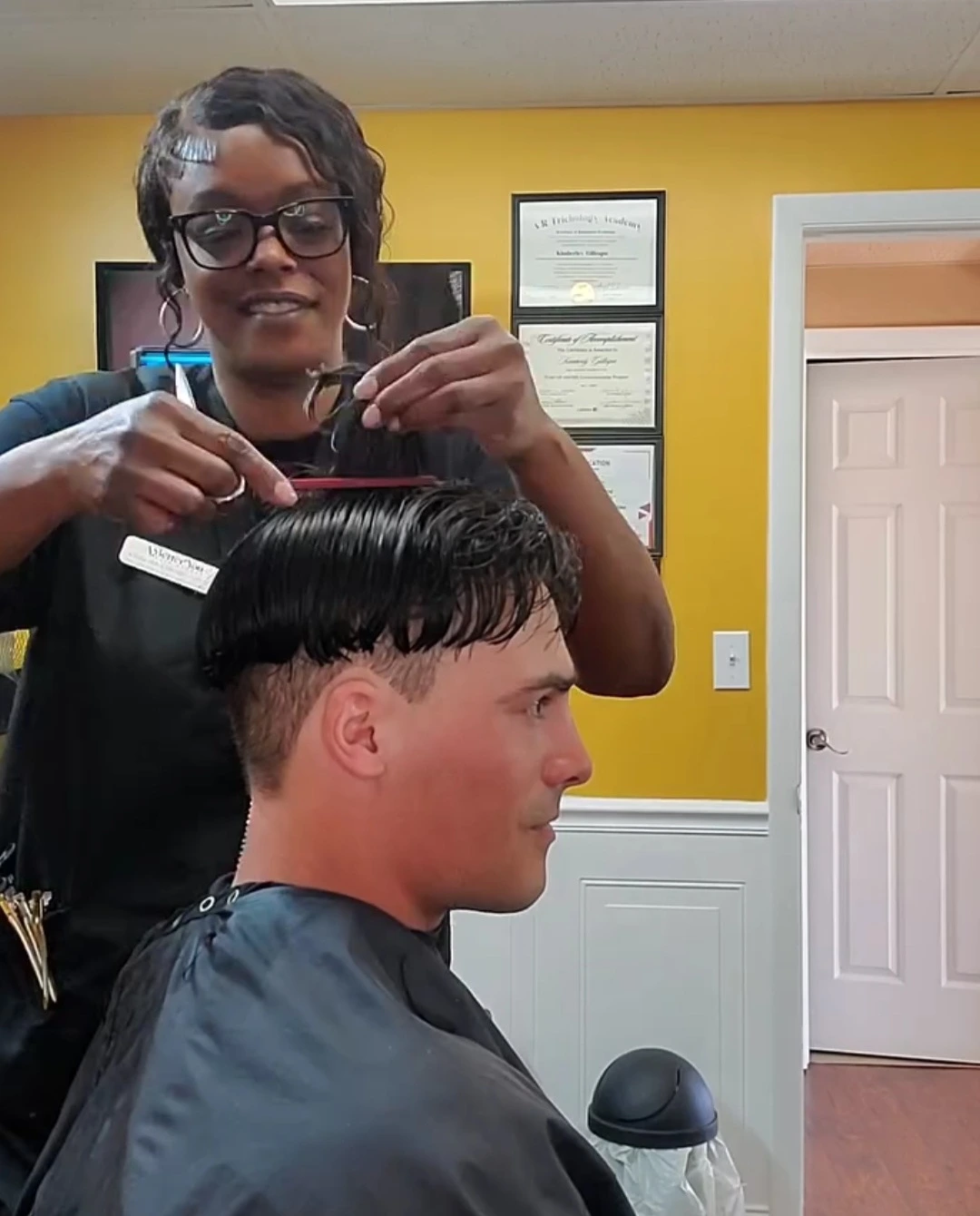 A Better You Hair Studio specialist applying specialized non-surgical hair replacement technique
